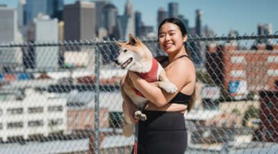 Happy woman holding dog